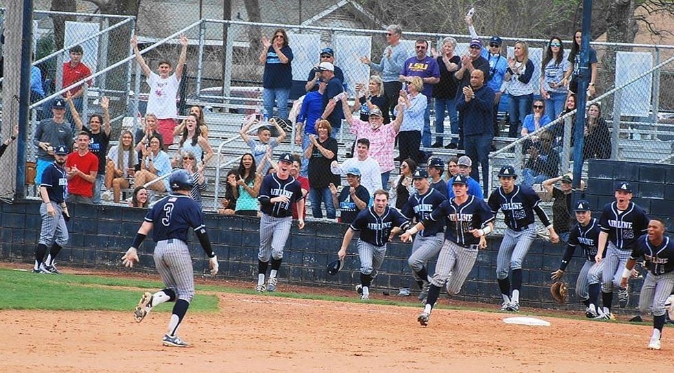 The Airline Viking baseball team celebrates a walk-off win against Ruston in their final...