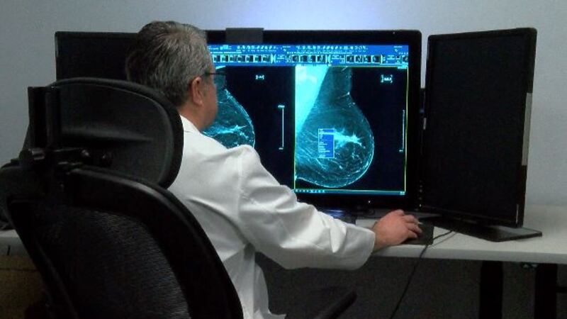 Radiologist Dr. Richard Martinez evaluates a mammogram. The Covid vaccine may cause temporary...
