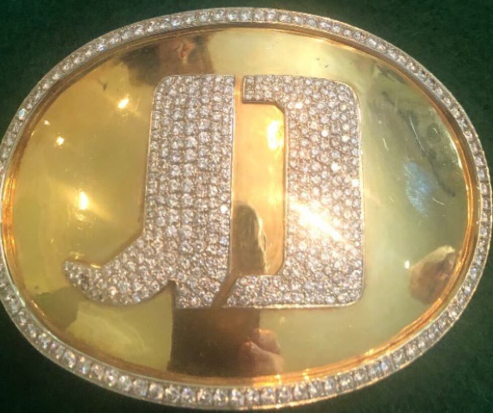 14K yellow gold oval shaped belt buckle measuring 4.5”x3.25” with Jimmy Dean’s initials in the...