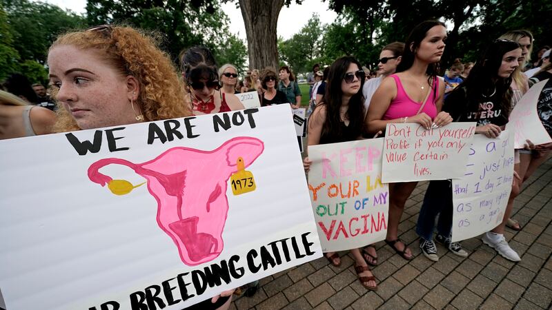 FILE - Abortion-rights advocates gather outside a the Kansas Statehouse to protest the U.S....
