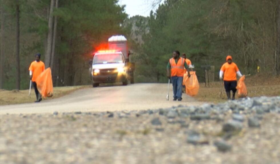 Members of a Webster Parish inmate crew pick up trash along a rural road in the parish.
