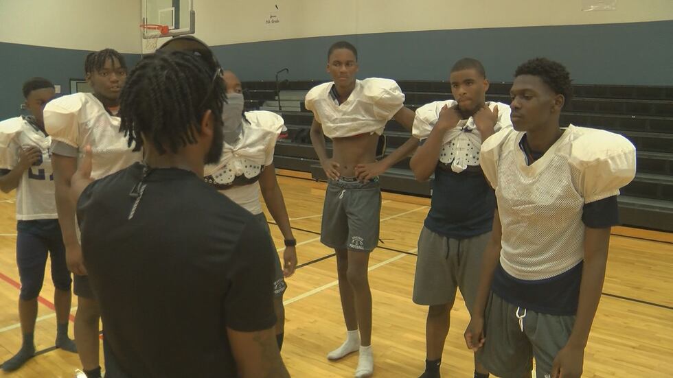 Coach speaking to players during practice