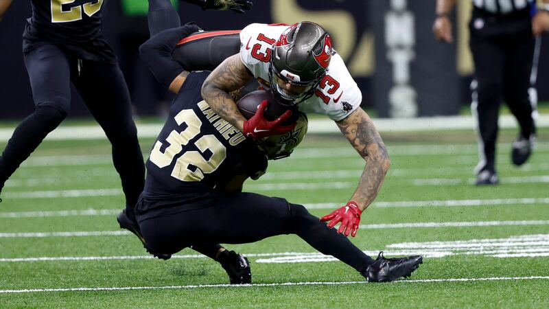 Tampa Bay Buccaneers wide receiver Mike Evans is tackled by New Orleans Saints safety Tyrann...