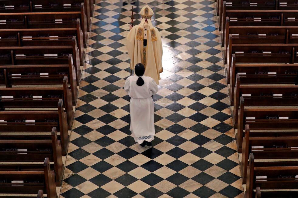 FILE - Archbishop Gregory Aymond conducts a procession to lead a live streamed Easter Mass in...
