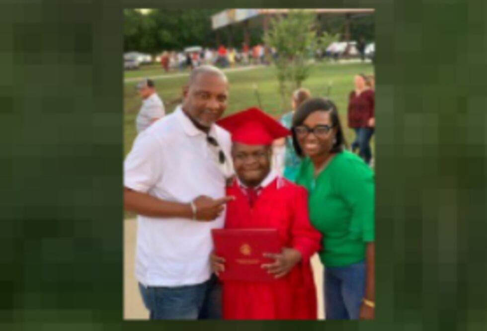 A proud Paul Mashall, Junior posing with his parents on graduation day.