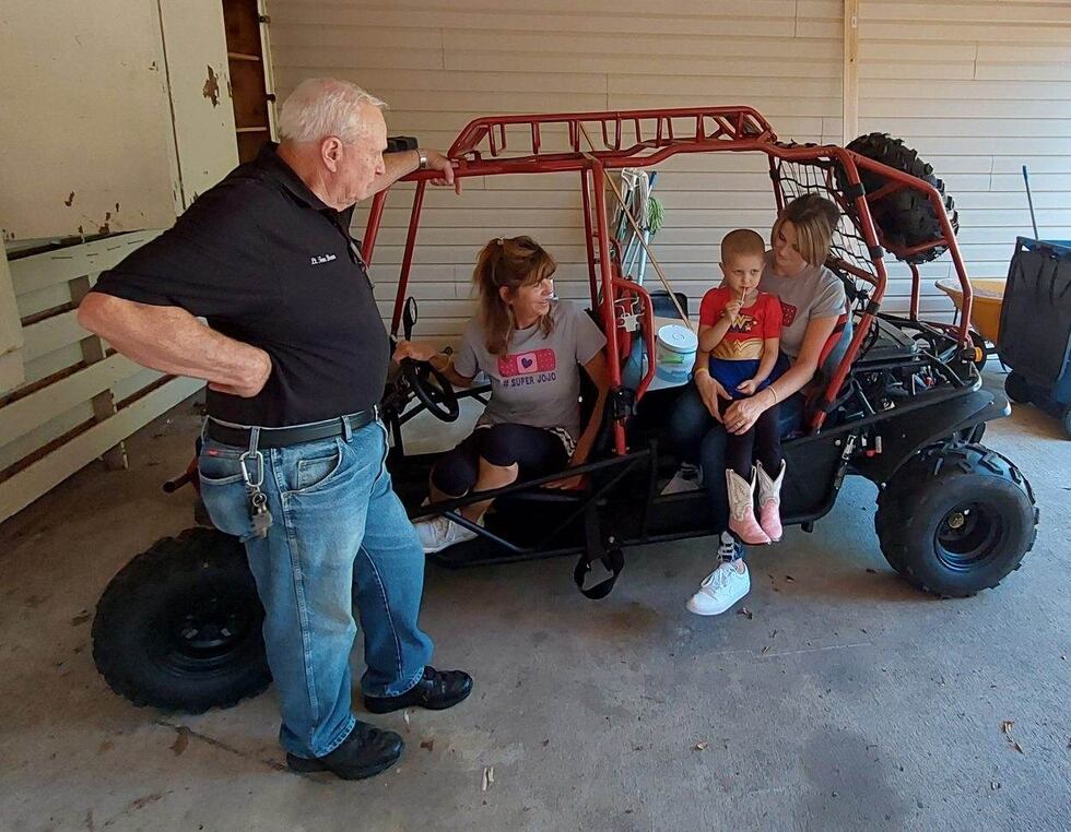 JoJo sits on her mother's lap after the Scrivner family's go-cart was returned.