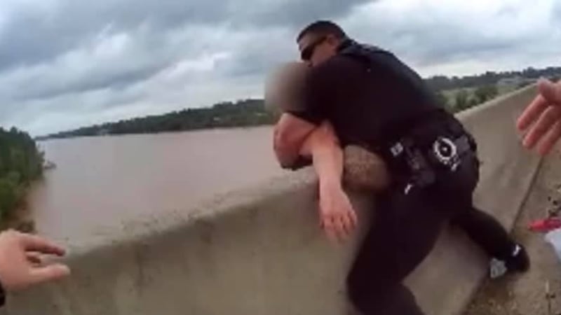 Bossier City police officers rush in to rescue a person on the Shreveport-Barksdale Bridge on...