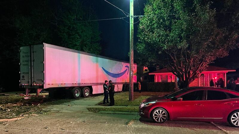 Officials respond to Curtis Lane where an 18-wheeler crashed into a home.