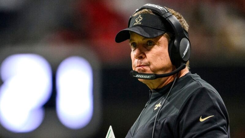 New Orleans Saints head coach Sean Payton works during the first half of an NFL football game...