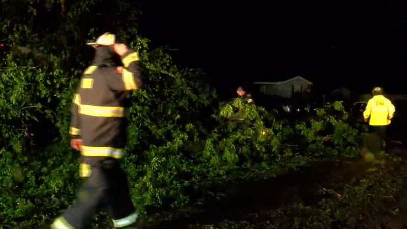 First responders work to remove trees downed during tornadic storms the night of April 12, 2022.